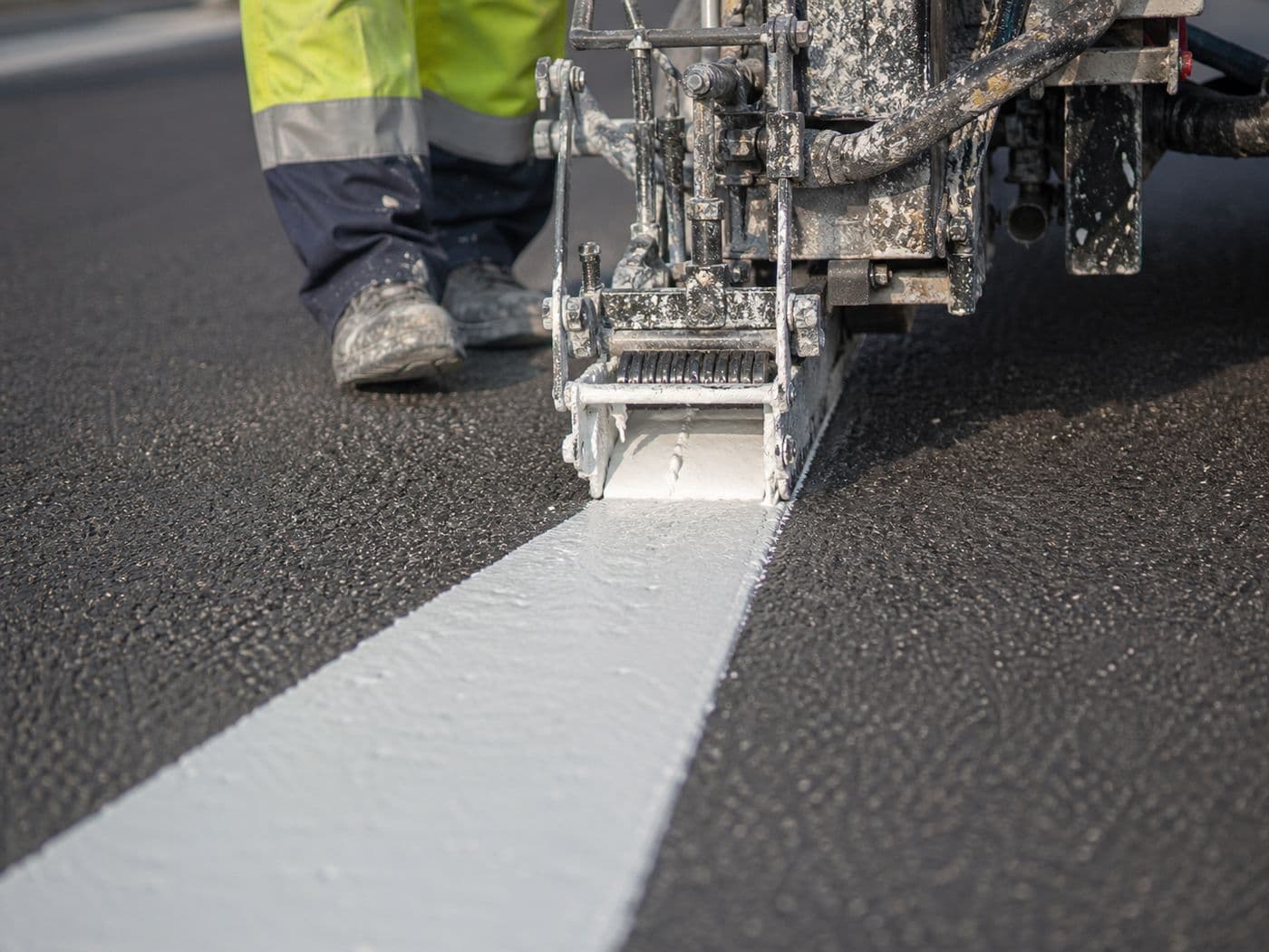 Road marking paint being applied
